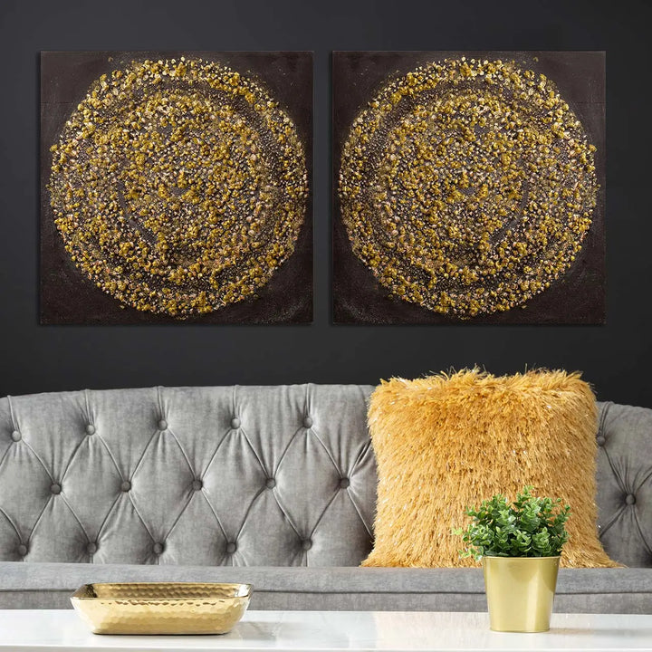 Two circular wall art pieces on a black wall above a gray sofa with a yellow pillow.