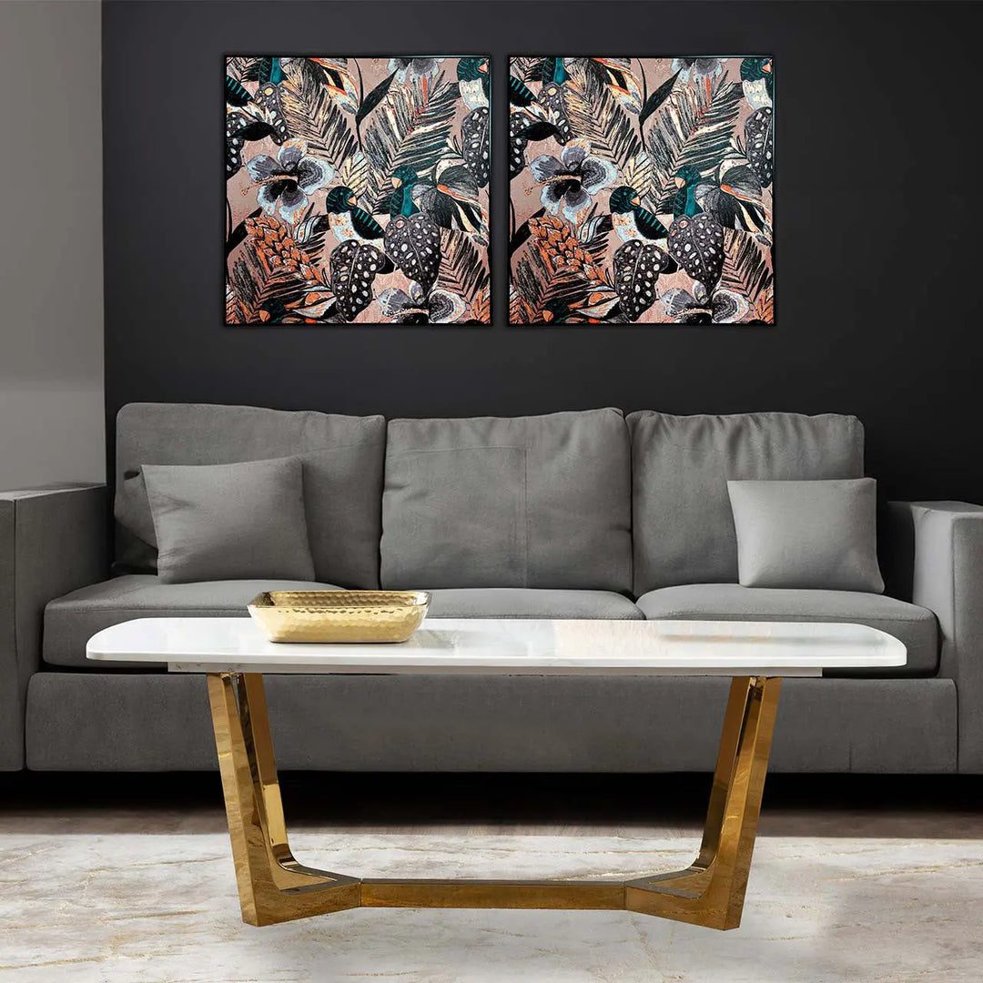 Gray sofa with a wooden coffee table in a living room setting, featuring two floral wall art pieces.