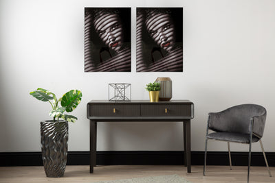 Modern interior with a console table, chair, and decorative items against a white wall.