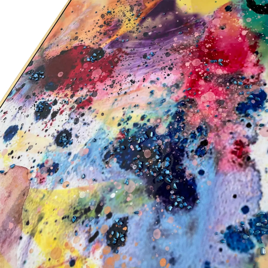 Colorful abstract art with splashes of red, yellow, blue, and black on a white background.
