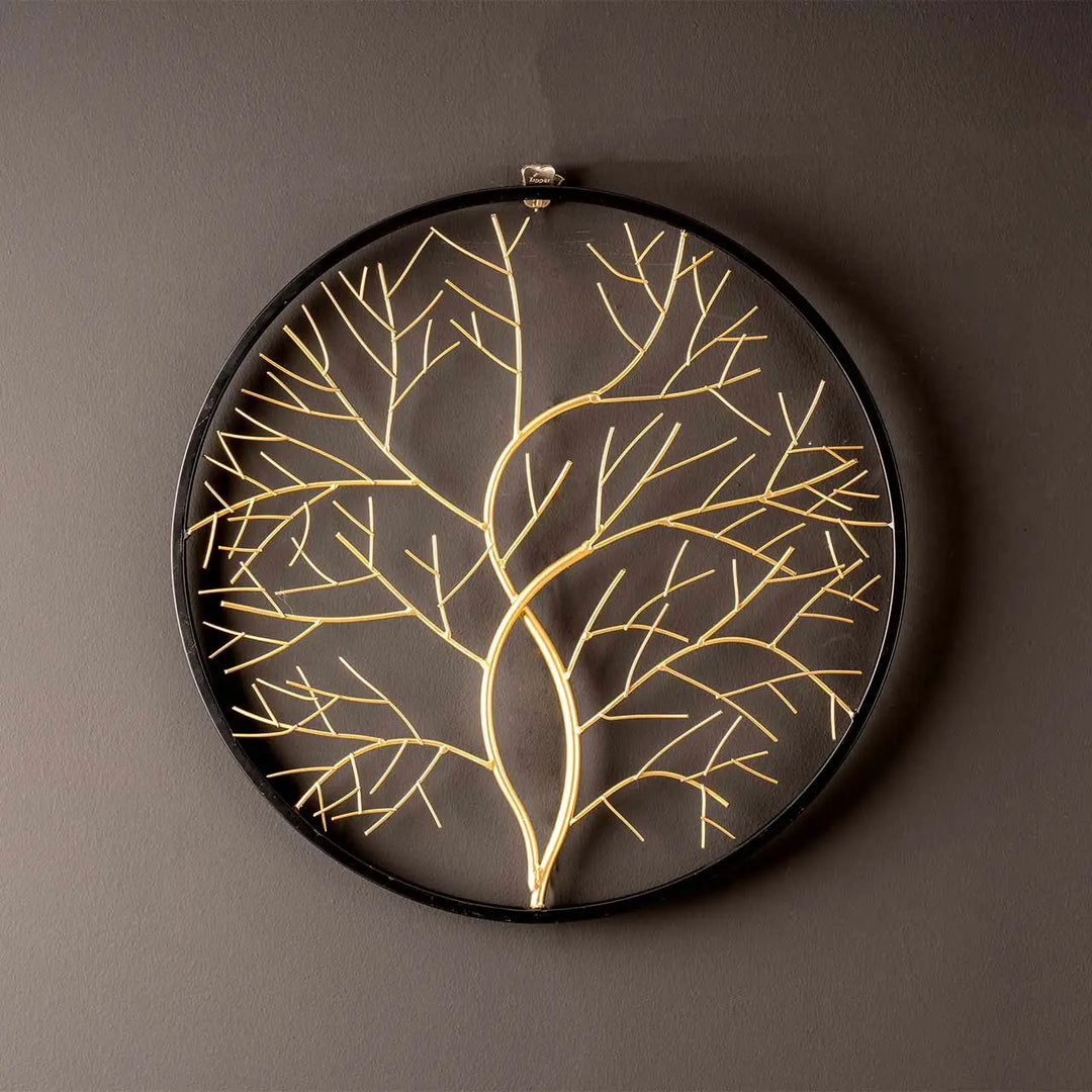 Decorative wall art with gold leaf pattern on a dark background