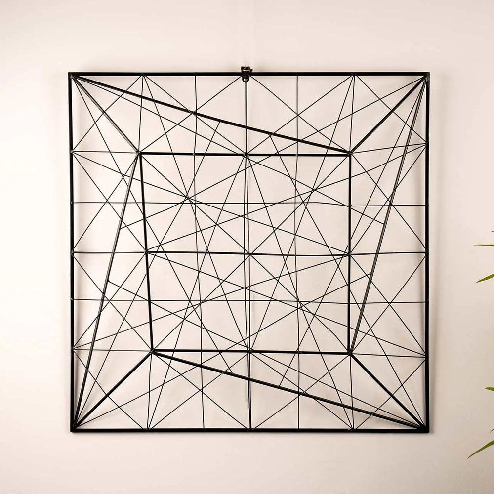 Geometric wall art with black lines on a light beige background